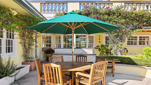 a outdoor space with patio the couches and a dining table with garden view