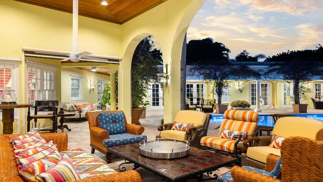a living room with furniture a fireplace and a floor to ceiling window