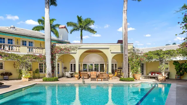 a view of a dining room with furniture large windows and wooden floor