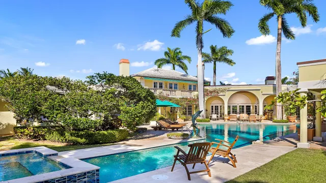 a view of a swimming pool with a patio and a garden