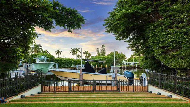 a view of a swimming pool with lawn chairs under an umbrella