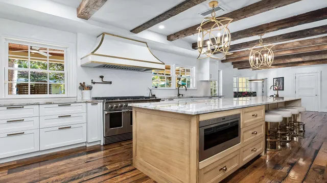 a kitchen with stainless steel appliances granite countertop a stove and cabinets