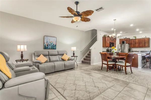 a living room with furniture and kitchen view