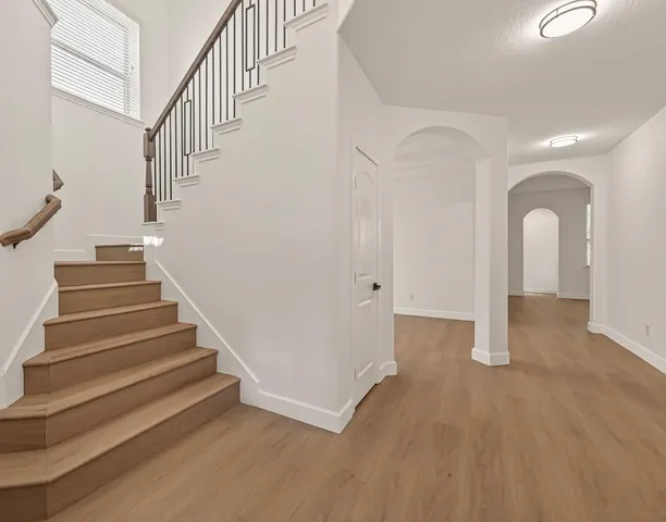 a view of entryway and hall with wooden floor