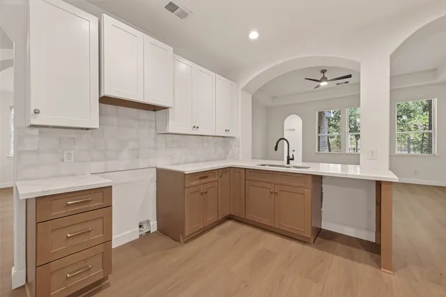 a kitchen with granite countertop white cabinets and white appliances