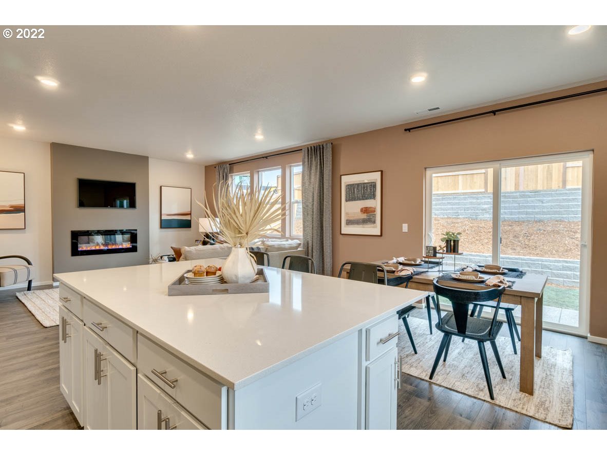 3122 Southeast 34th Way Gresham, OR 97080 - Photo 8 of 26 a kitchen with a table chairs and a refrigerator