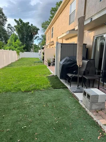 a front view of a house with garden and parking