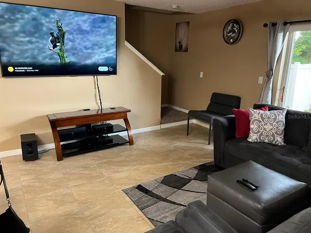 a kitchen with a sink a microwave a refrigerator and cabinets