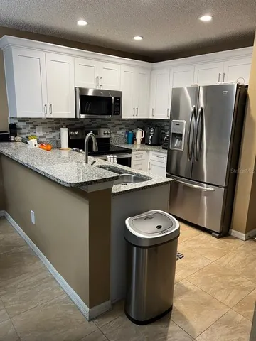 a dining room with furniture a rug and a chandelier
