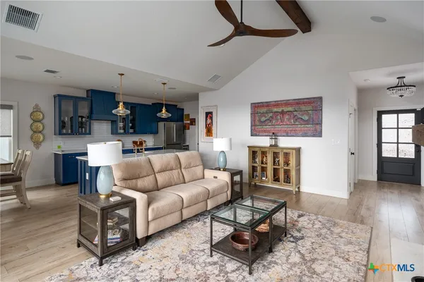a kitchen with kitchen island granite countertop a sink cabinets and wooden floor