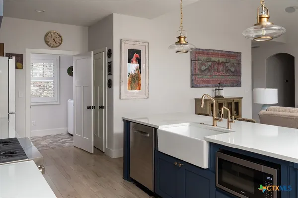a kitchen with sink cabinets and wooden floor