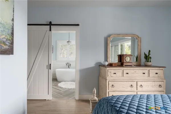 a white bath tub sitting in a bathroom next to a window
