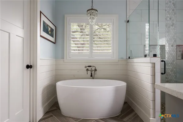 a bathroom with a shower and a sink
