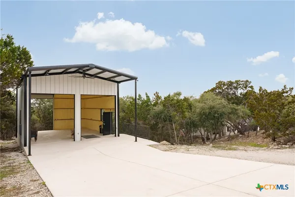 a view of a white house with a sink and table chair