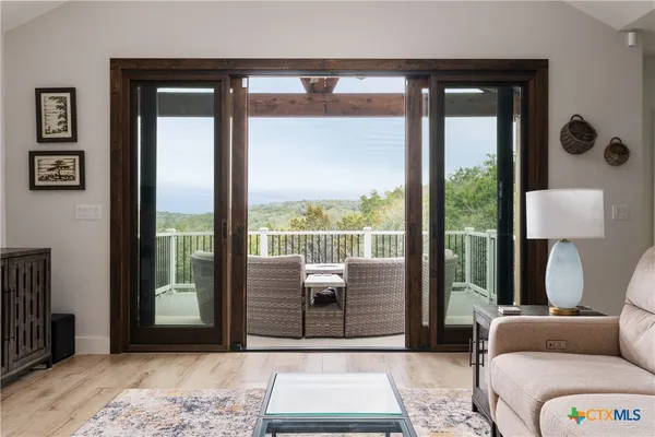 a view of a patio with couches table and chairs and potted plants