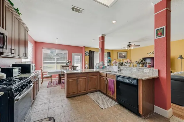 a kitchen with stainless steel appliances granite countertop a stove and a sink