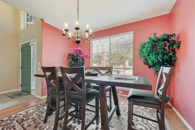 a view of a dining room with furniture and a potted plant