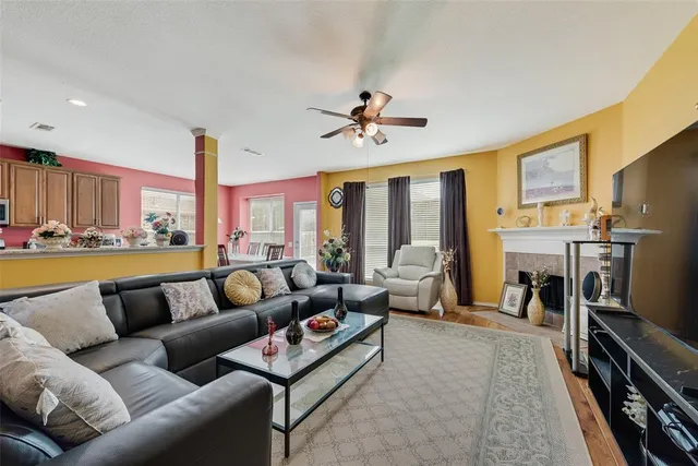 a living room with furniture a fireplace and a flat screen tv