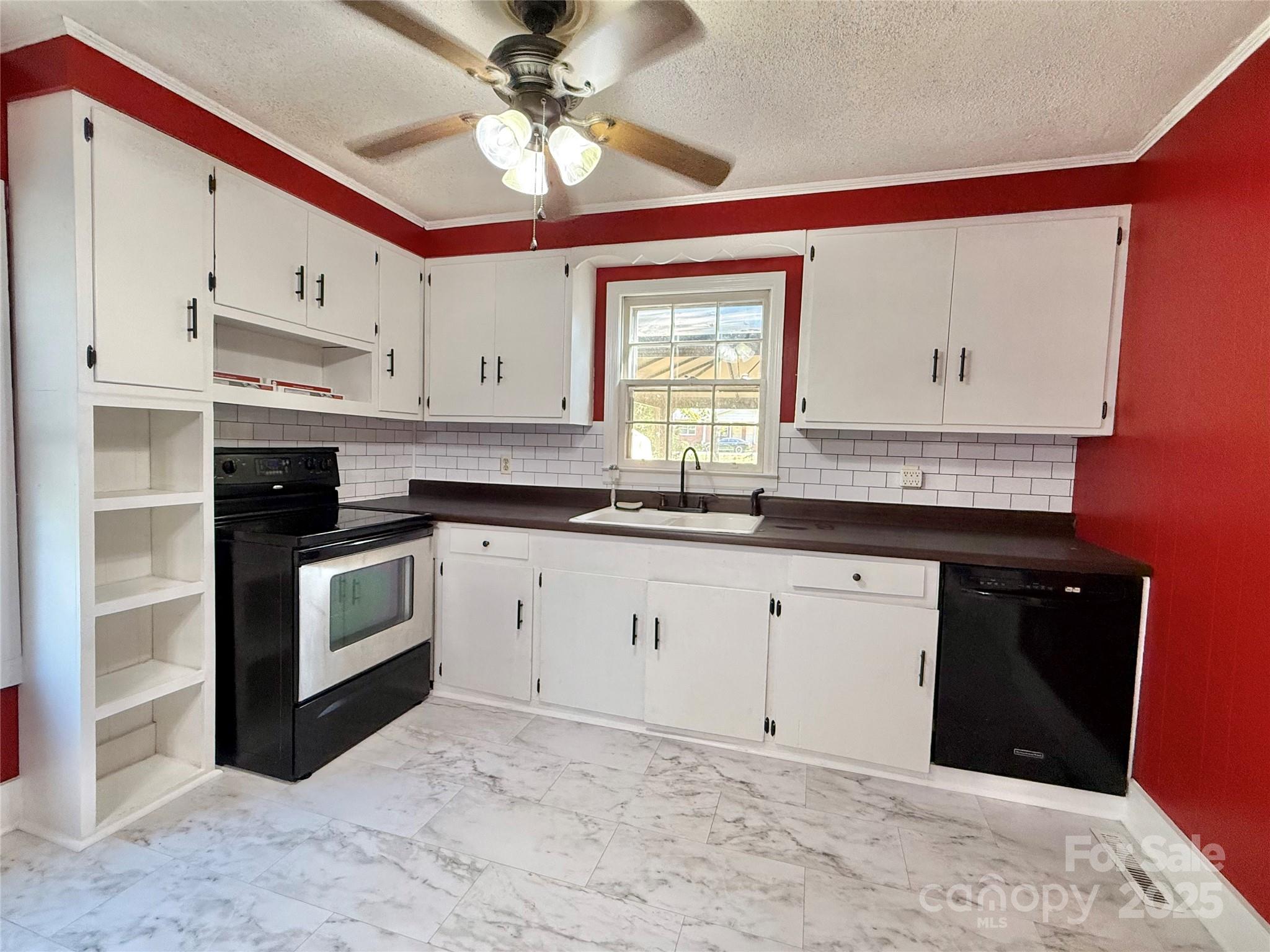 117 Pine Street Chester, SC 29706 - Photo 3 of 19 a kitchen with stainless steel appliances granite countertop a stove a sink and a refrigerator