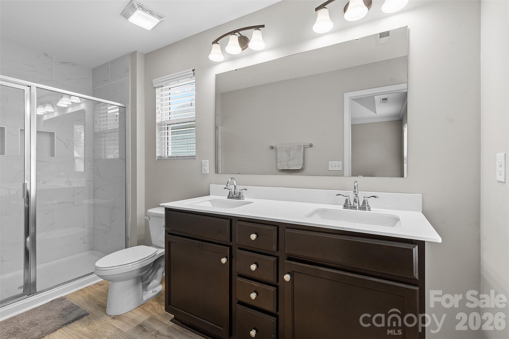 209 Shay Xing Road Salisbury, NC 28146 - Photo 11 of 20 a bathroom with a toilet a sink a mirror and a shower