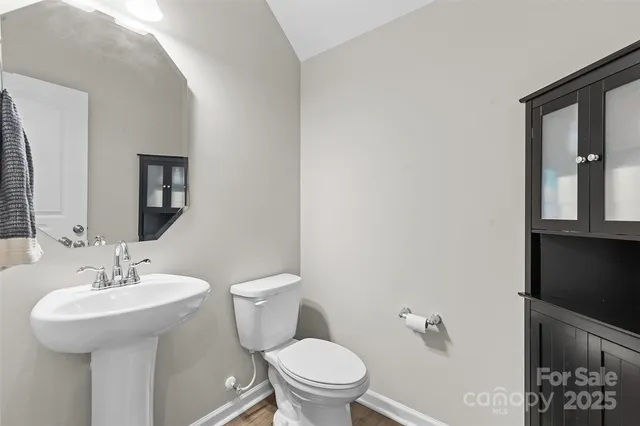 a bathroom with a sink toilet and mirror