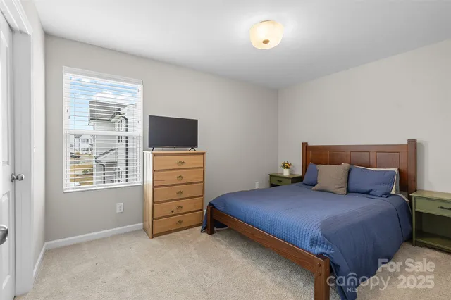 a bedroom with a bed and a tv