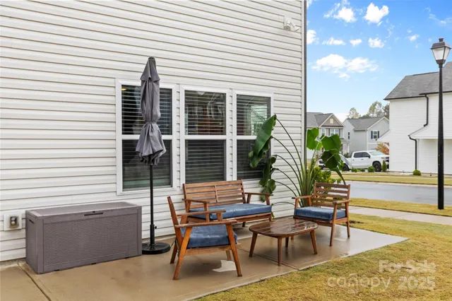 a view of a chairs and table in the back yard