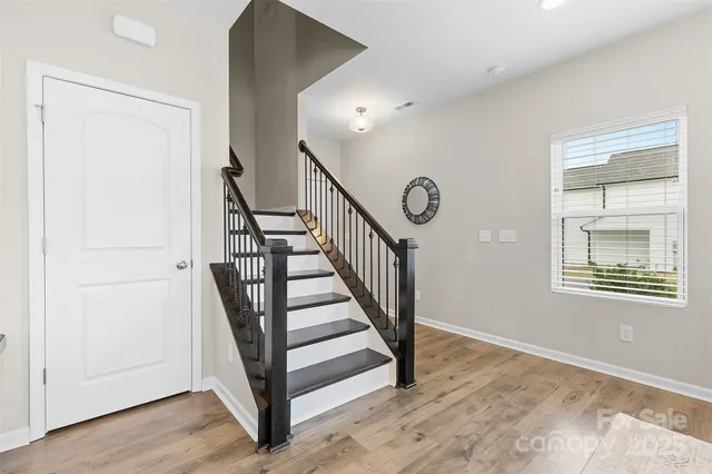 a view of entryway and hall with wooden floor