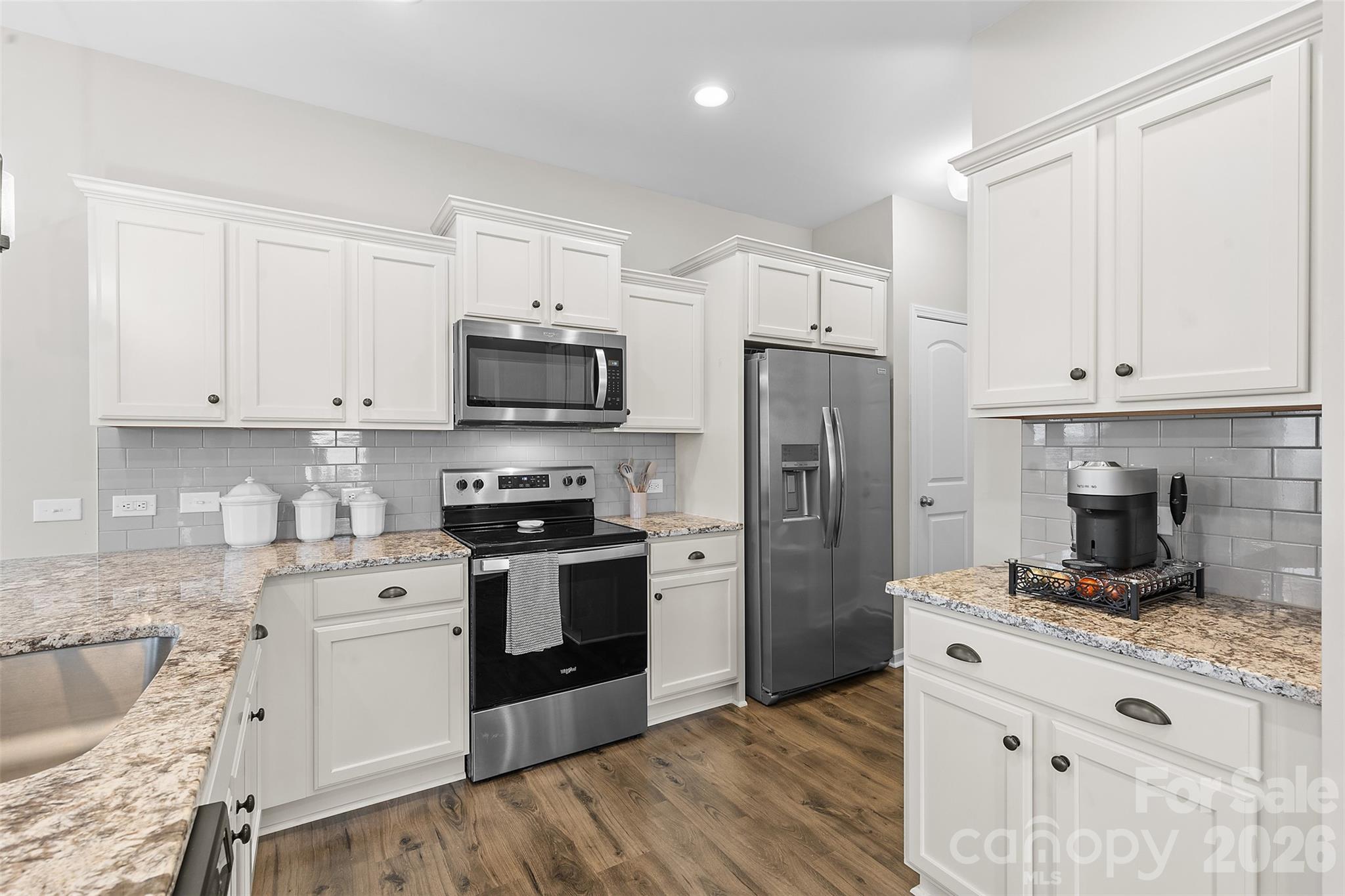209 Shay Xing Road Salisbury, NC 28146 - Photo 8 of 20 a kitchen with refrigerator a stove a sink and white cabinets