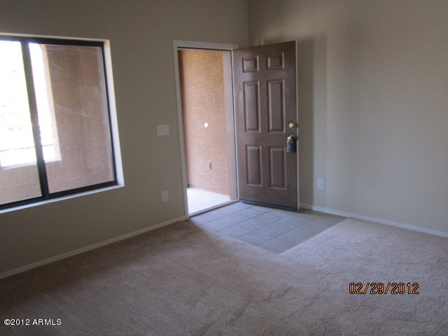 941 West Carter Road Phoenix, AZ 85041 - Photo 2 of 10 an empty room with windows