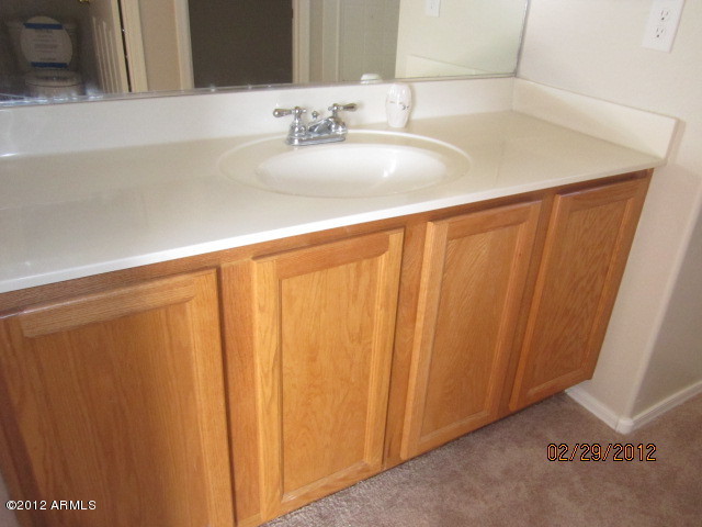 941 West Carter Road Phoenix, AZ 85041 - Photo 6 of 10 a bathroom with a sink and a mirror