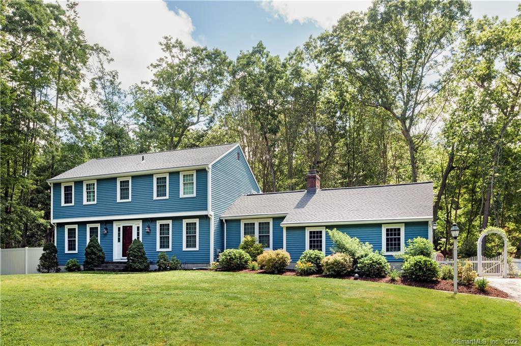 54 Country Way Madison, CT 06443 - Photo 1 of 1 a front view of a house with garden and trees