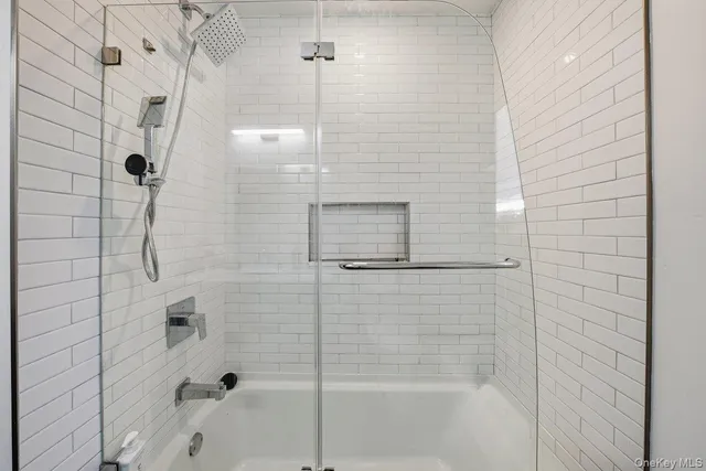 a bathroom with a bathtub and shower
