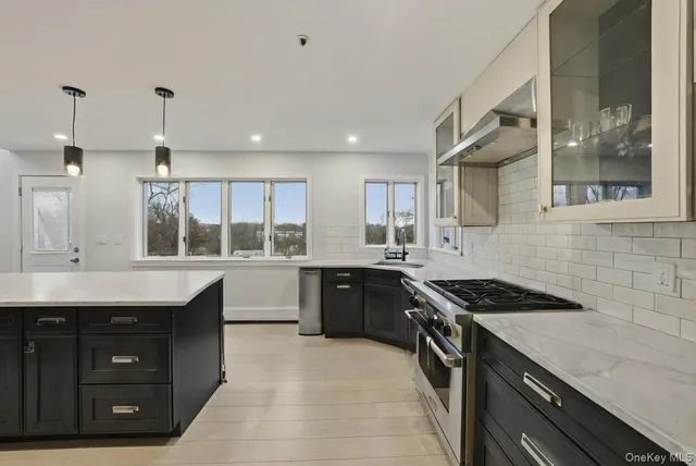 a kitchen with a sink stove and cabinets