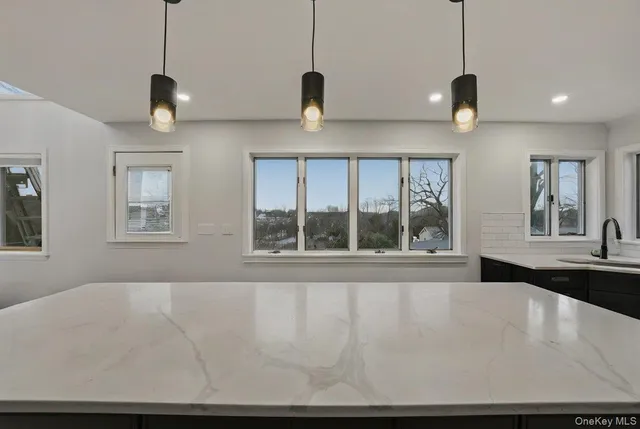 a view of a room with a large window and chandelier