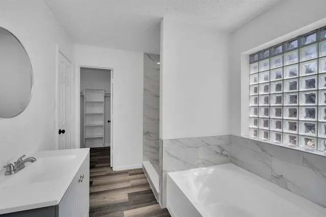 a bathroom with a bathtub and a sink