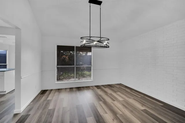 a view of a room with wooden floor and exposed radiator