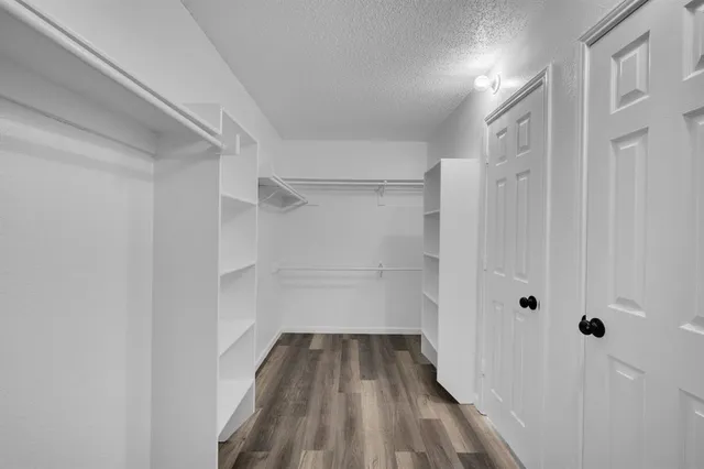 a view of a room with wooden floor