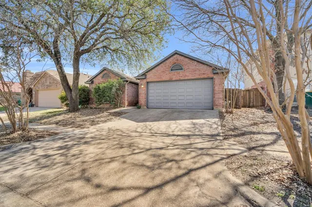 a front view of a house with a yard covered in snow