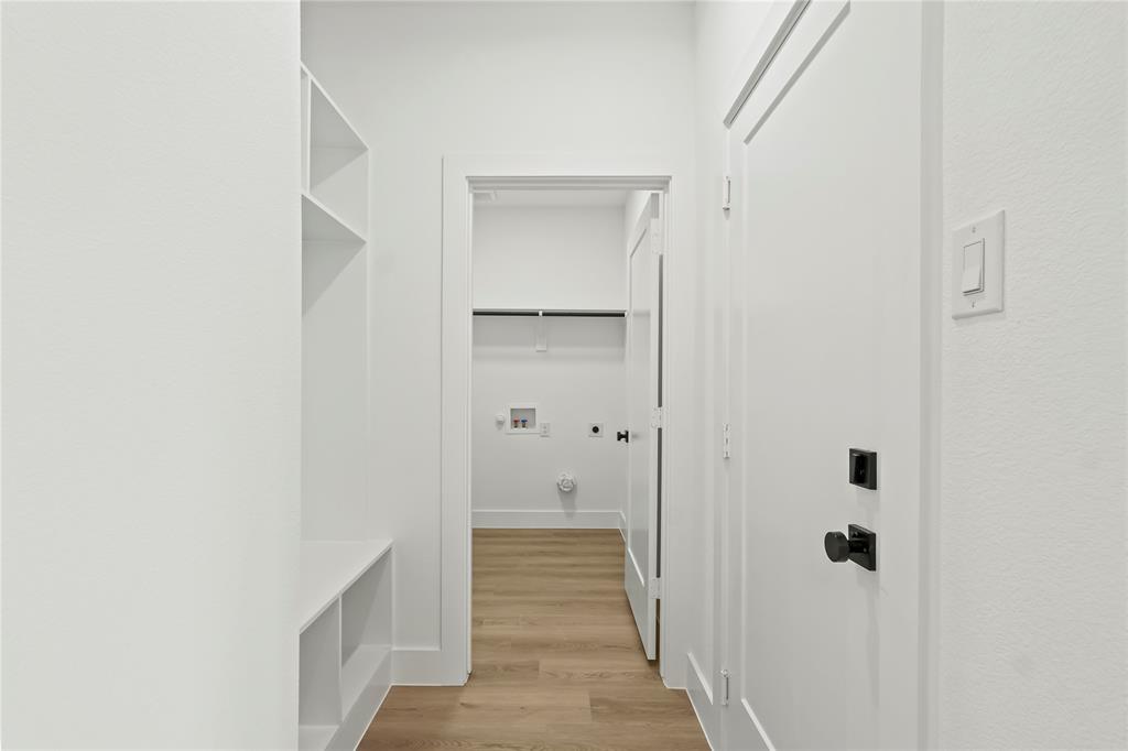 4827 Baldwin Street Dallas, TX 75210 - Photo 11 of 21 a view of a hallway with wooden floor and closet