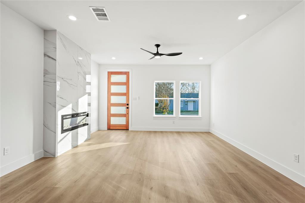 4827 Baldwin Street Dallas, TX 75210 - Photo 9 of 21 wooden floor in an empty room with a window