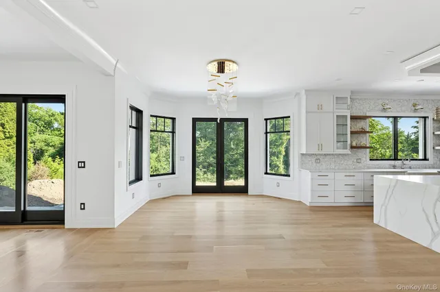 a view of a kitchen with microwave and window