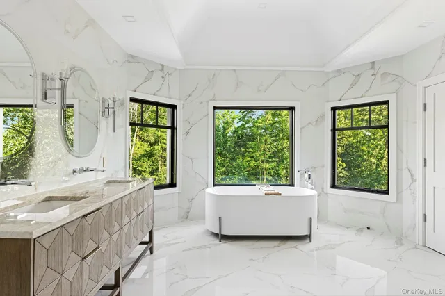 a bathroom with a sink mirror and a bathtub