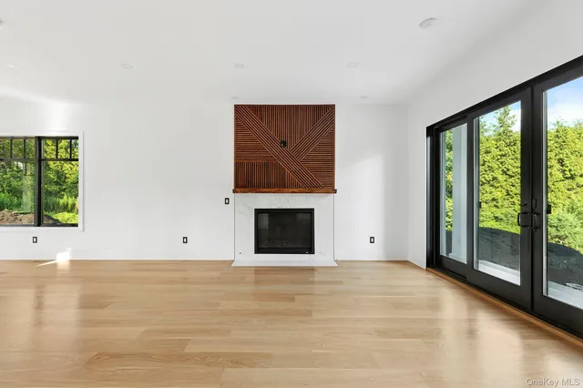 a view of an empty room with window and fire place