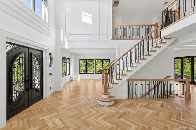 a view of entryway and hall with wooden floor