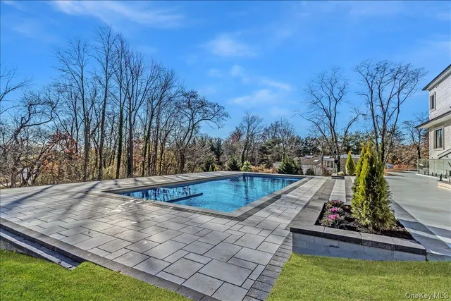 a view of a backyard with swimming pool