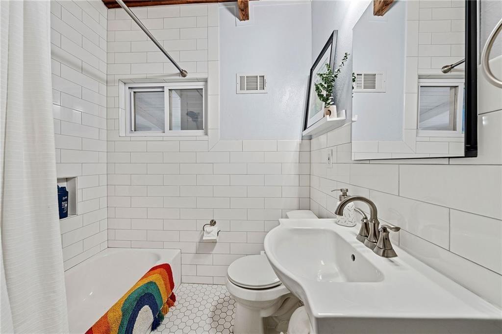 2632 Defoors Ferry Road Northwest Atlanta, GA 30318 - Photo 17 of 22 a bathroom with a sink and a toilet
