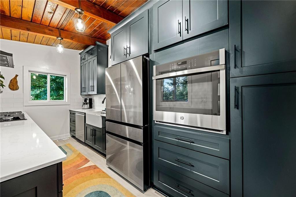 2632 Defoors Ferry Road Northwest Atlanta, GA 30318 - Photo 8 of 22 a kitchen with granite countertop a refrigerator and a stove