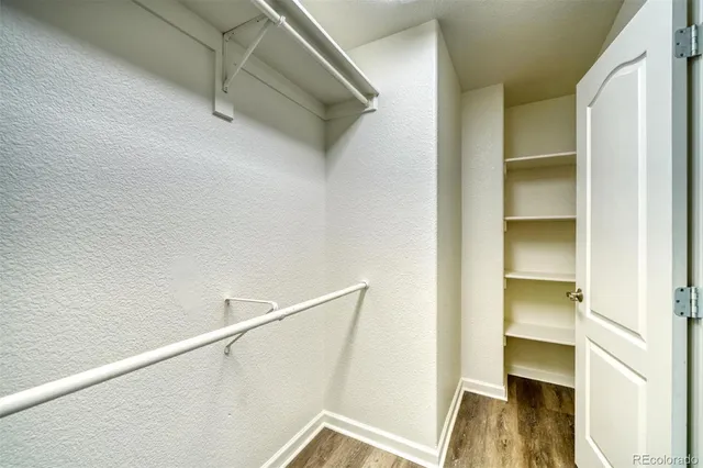 a bathroom with a granite countertop sink toilet mirror and bathtub