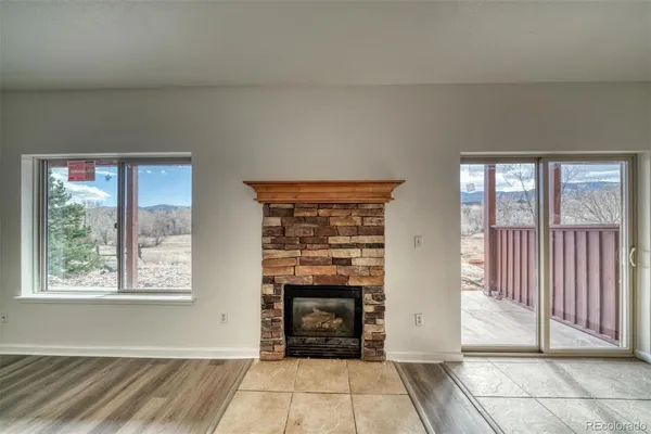 a view of a livingroom with entryway and an empty room